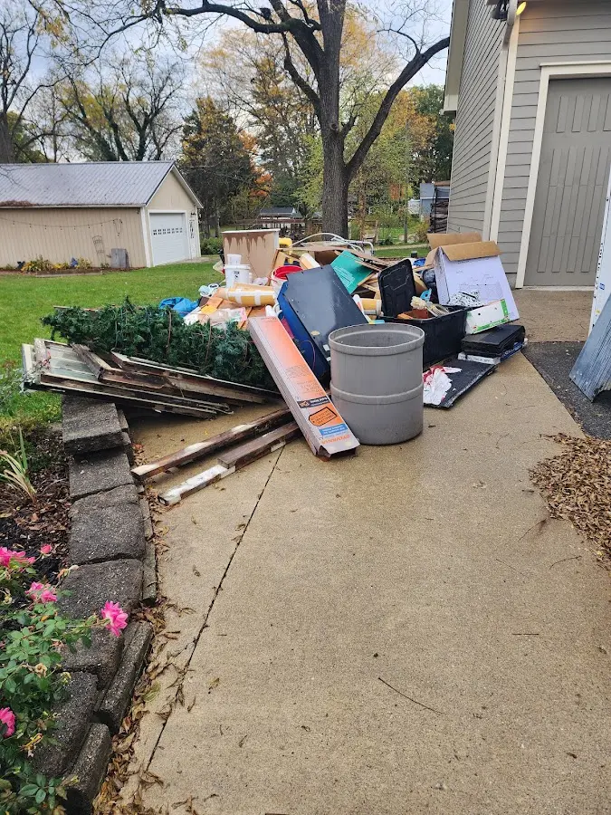 Dumpster being loaded with debris for Estate Cleanout Dumpster Rental in Forest Hill